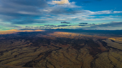 aerial view of a colorful landscape and sky with clouds