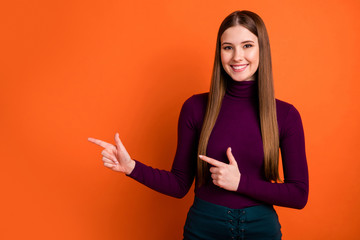 Photo positive cheerful girl promoter point index finger copyspace present adverts promotion...