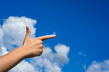 Woman pointing his hand and cloud sky background