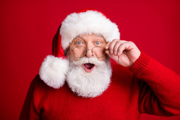 What x-mas discounts. Shocked old man pensioner retired in santa claus hat look incredible holiday newyear news touch eyeglasses eyewear wear bright swearer isolated shine color background