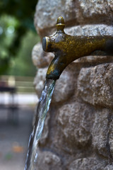 Vintage metal and rock fountain, with water jet