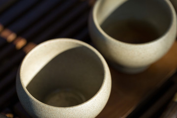 Ceramic bowls made of clay on a wooden background.