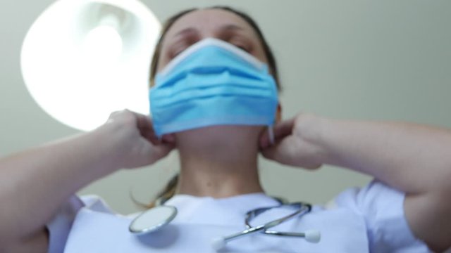Blurred Image of Doctor in Hospital Emergency Room Wearing Protective Face Mask Due to Coronavirus Pandemic Epidemic Crisis