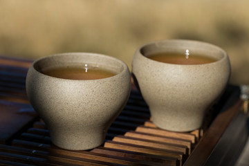 Ceramic bowls made of clay on a wooden background.