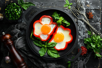 Fried scrambled eggs with sweet pepper in a pan. Top view. Free space for your text.