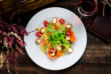 summer salad on a plate with fresh vegetables, seasonal offer for the menu