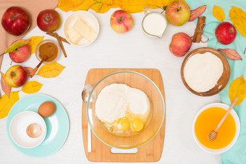 ingredients and recipe for homemade Apple cupcakes and muffins, top view light background, yellow leaves. the concept of fall baking and fall harvest. mixing flour, eggs and butter, knead the dough