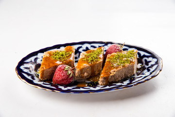 Isolated oriental baklava with honey pistachios