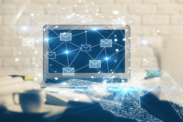 Desktop computer background in office and flying envelops hologram drawing. Double exposure. Electronic mail concept.