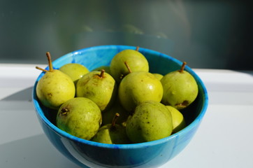 Fresh little pear in the blue plate.