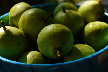 Fresh little pear in the blue plate.