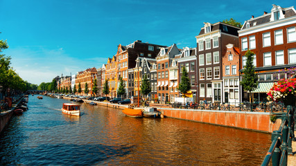 Canal in Amsterdam with pleasure boat