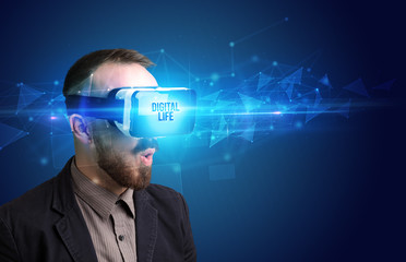 Businessman looking through Virtual Reality glasses with DIGITAL LIFE inscription, cyber security concept