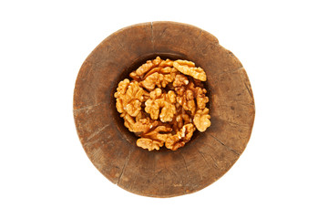 Walnuts in antique, wooden mortar.