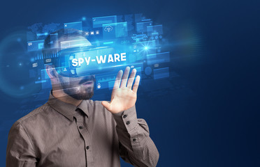 Businessman looking through Virtual Reality glasses with SPY-WARE inscription, innovative security concept