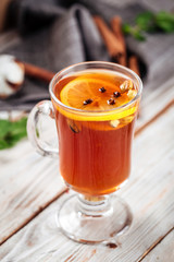 Moroccan tea with lemon and spices in a glass mug