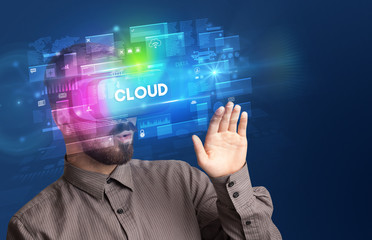 Businessman looking through Virtual Reality glasses with CLOUD inscription, innovative security concept