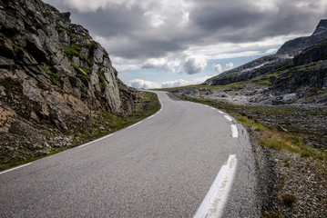 Empty road. road to clouds. rocky road goes into the distance into the blue sky.  Beautiful Norway landscape, Travel in Norway