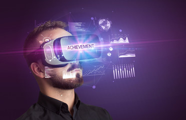 Businessman looking through Virtual Reality glasses with ACHIEVEMENT inscription, new business concept