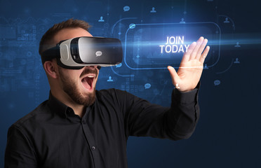Businessman looking through Virtual Reality glasses with JOIN TODAY inscription, social networking concept