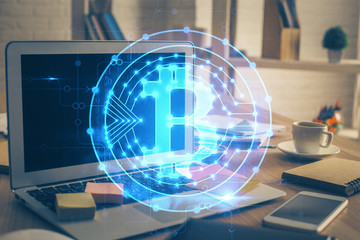 Multi exposure of blockchain theme hologram and table with computer background. Concept of bitcoin...