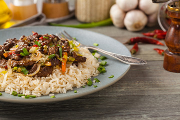 Traditional Korean Bulgogi dish.  Thinly cut, grilled beef, served with rice and vegetables.