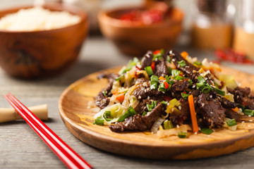 Traditional Korean Bulgogi dish.  Thinly cut, grilled beef, served with rice and vegetables.