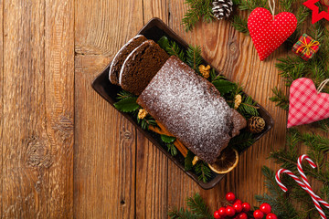 Homemade gingerbread cake. Christmas decoration. Top view. Natural wooden background.