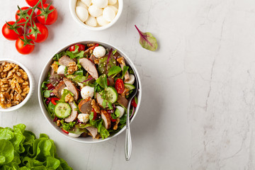 Salad with pork tenderloin, fresh cucumber and mozzarella.