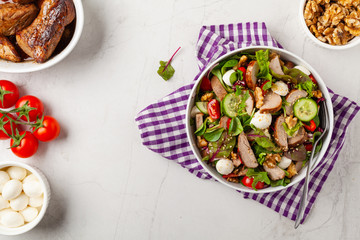 Salad with pork tenderloin, fresh cucumber and mozzarella.