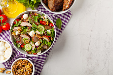 Salad with pork tenderloin, fresh cucumber and mozzarella.