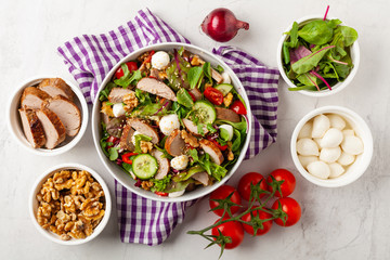 Salad with pork tenderloin, fresh cucumber and mozzarella.