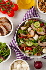 Salad with pork tenderloin, fresh cucumber and mozzarella.