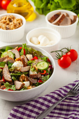 Salad with pork tenderloin, fresh cucumber and mozzarella.