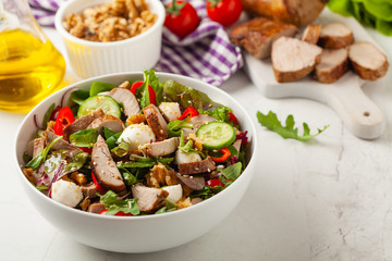 Salad with pork tenderloin, fresh cucumber and mozzarella.