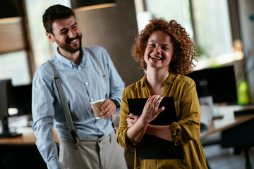 Colleagues in office. Businesswoman and businessman discussing work in office. Two friends in working together.