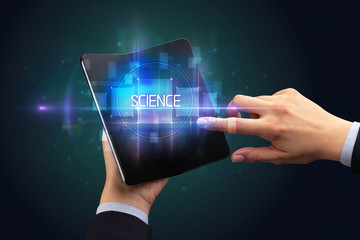 Businessman holding a foldable smartphone with SCIENCE inscription, new technology concept