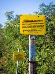 Yellow sign of forbidden area of military ground