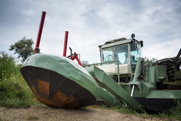 Swimming excavator on a lake in Burgenland