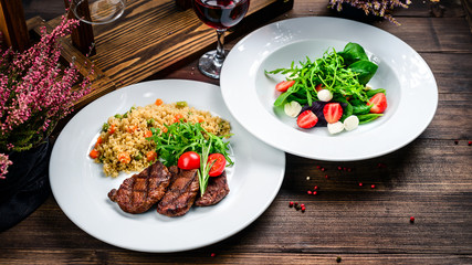 two course lunch grilled meat and fresh vegetable salad on the table