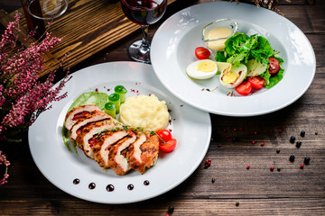 two course lunch grilled meat and fresh vegetable salad on the table