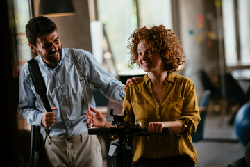 Colleagues in office. Businesswoman and businessman discussing work in office. Two friends in working together.