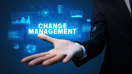 Hand of Businessman holding CHANGE MANAGEMENT inscription, business success concept