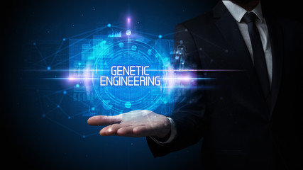 Man hand holding GENETIC ENGINEERING inscription, technology concept