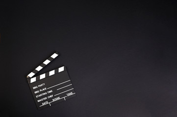 clapper board or movie slate.It is used in video production and film industry on black background. High quality photo. Copy space. 