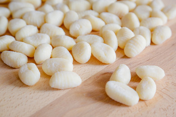 Gnocchi, typical italian pasta, on wooden table, natural light