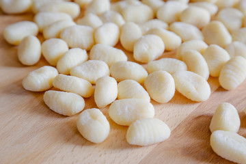 Gnocchi, typical italian pasta, on wooden table, natural light