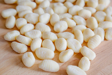 Gnocchi, typical italian pasta, on wooden table, natural light