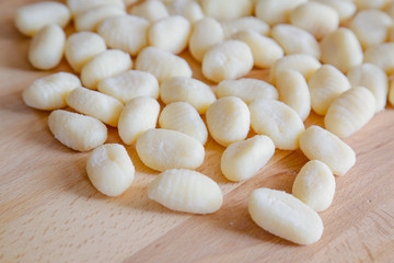 Gnocchi, typical italian pasta, on wooden table, natural light