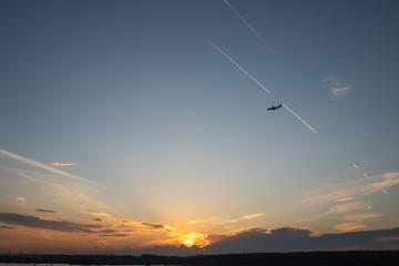 Obraz na płótnie Canvas Plane over the horizon. Sunset sky. 